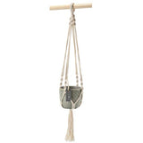 Macrame plant hanger with a pot on a white background