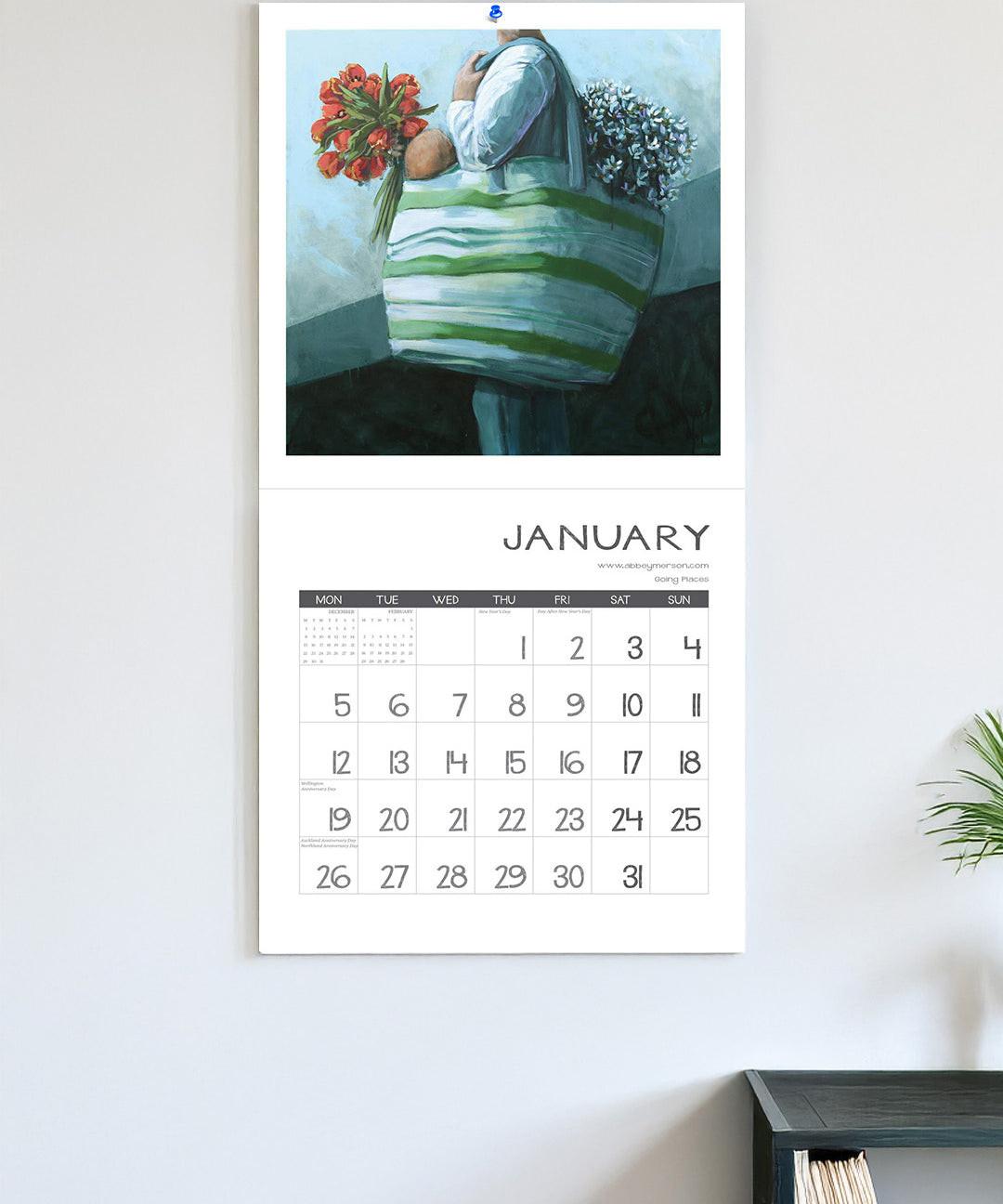 Calendar with a decorative illustration of a person holding flowers on a light gray wall.
