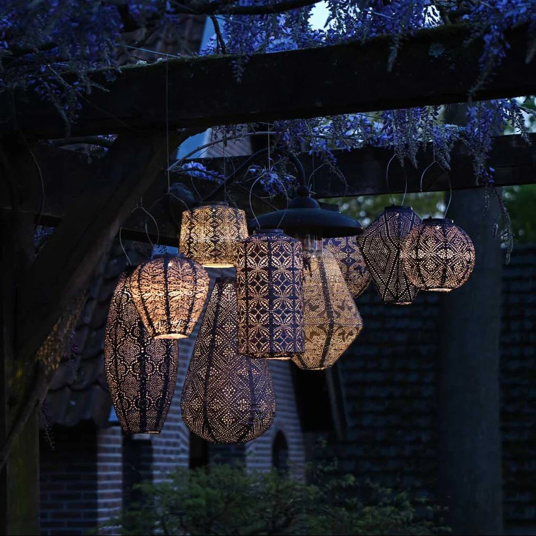 Night time photo of many hanging solar lanterns showing play on light patterns