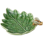 Ceramic leaf-shaped dish with a bee figurine on a white background