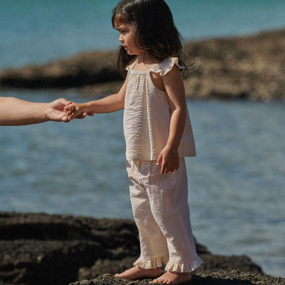 girl wearing Yellow and white strip top and pant set