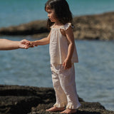 girl wearing Yellow and white strip top and pant set