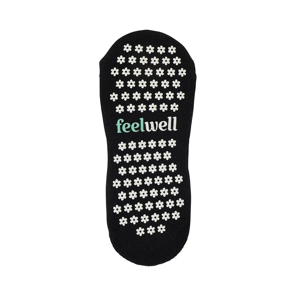 Black sole with white floral patterns and 'feelwell' branding on a white background
