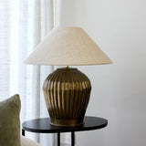 Ribbed antique gold bulbulus lampbase with natural coloured shade shade