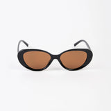 Black cat-eye sunglasses with brown lenses on a white background
