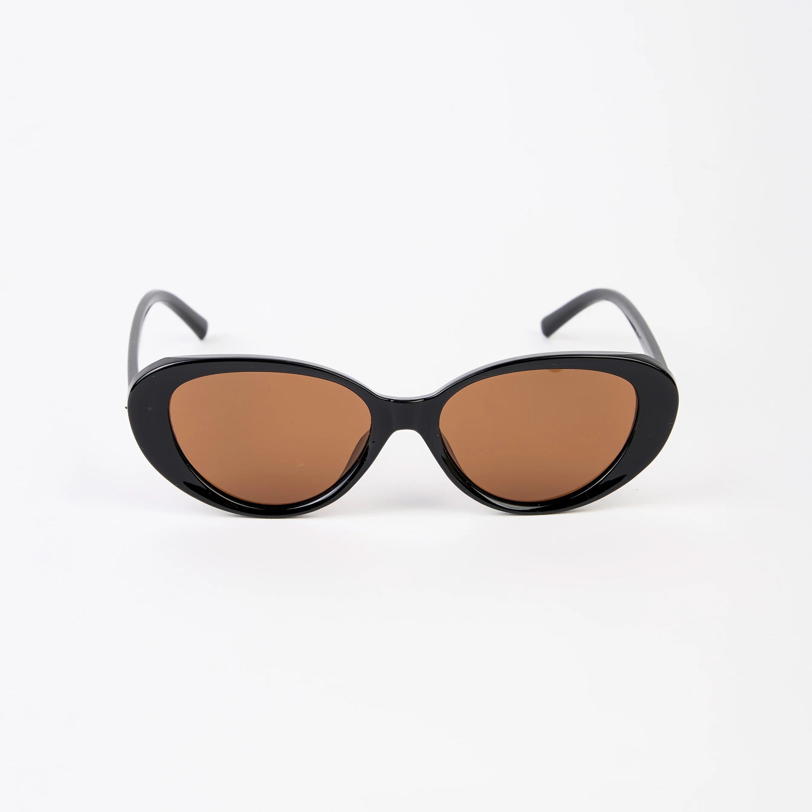 Black cat-eye sunglasses with brown lenses on a white background