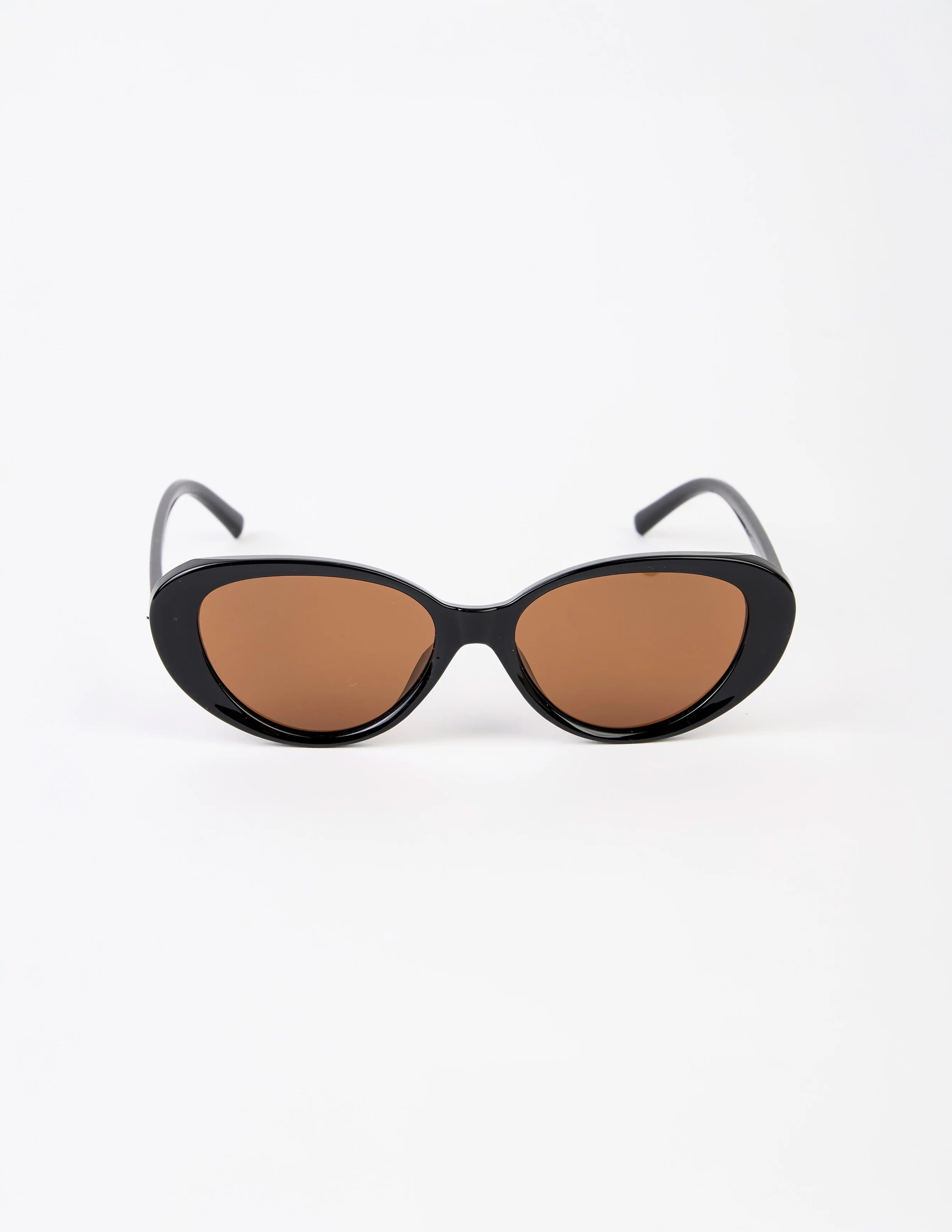 Black cat-eye sunglasses with brown lenses on a white background