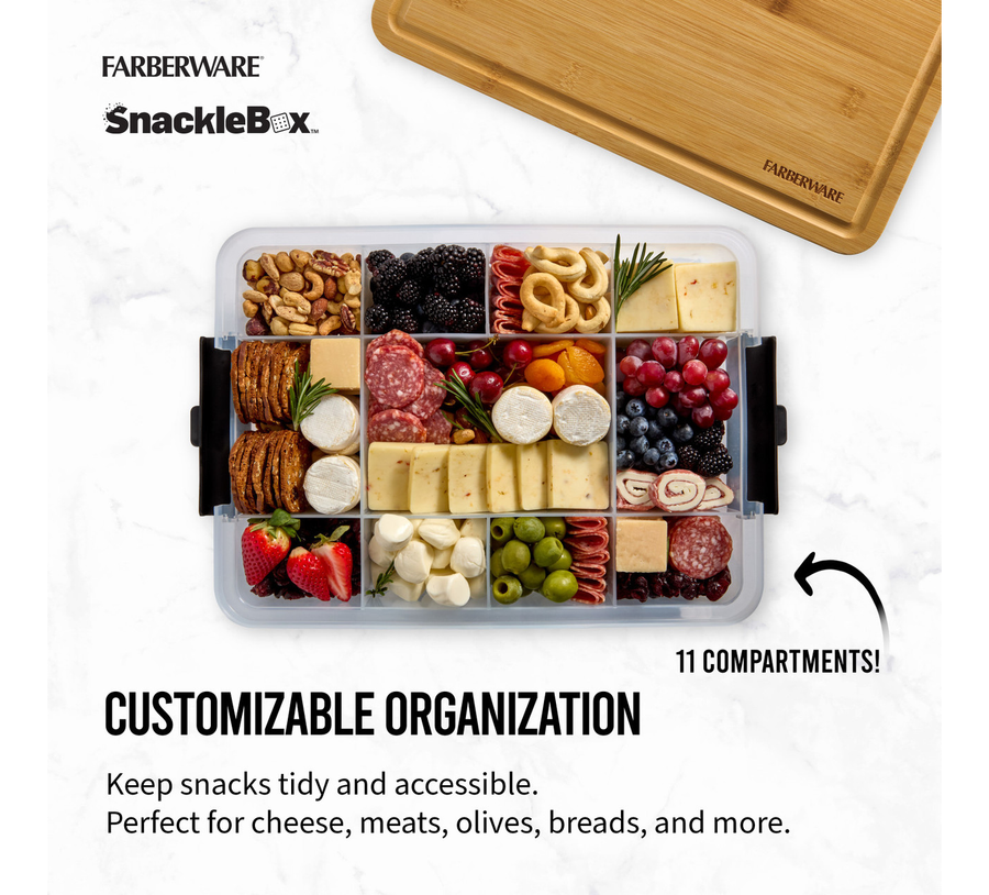 Farberware SnackleBox with various snacks and a wooden cutting board on a white background
