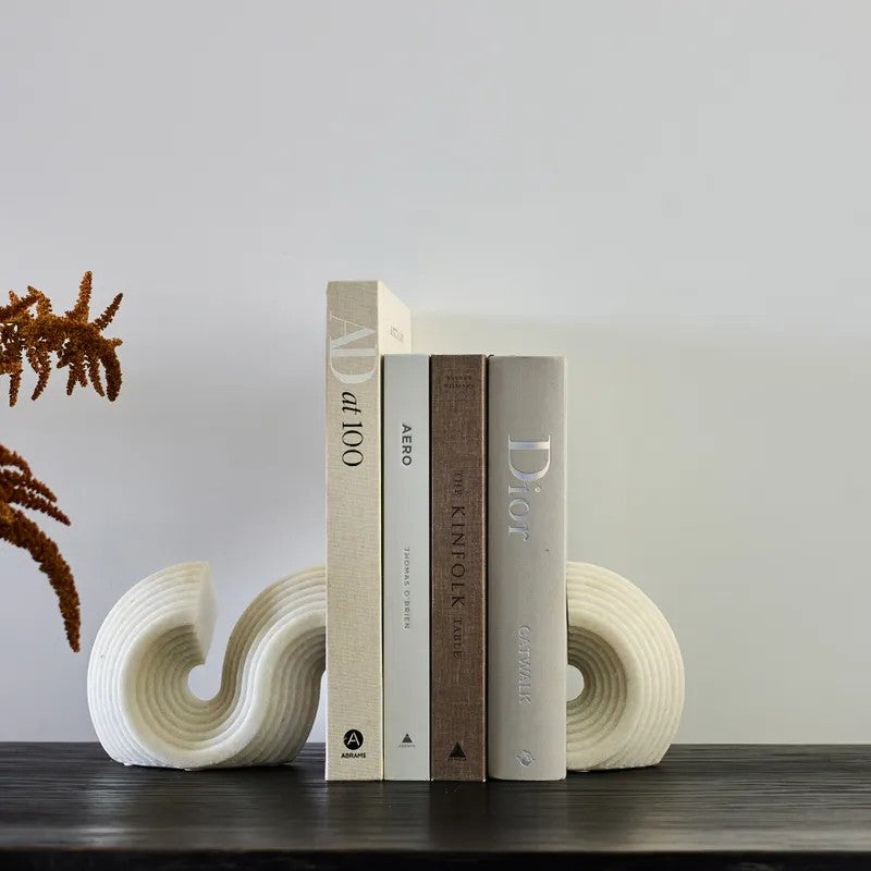 S shaped bookends displayed on bookshelf with books