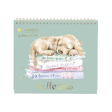 Calendar with a puppy on top of books titled 'hello 2026' by Wrendale Designs.