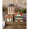 Set of miniature houses on a wooden surface with a neutral background