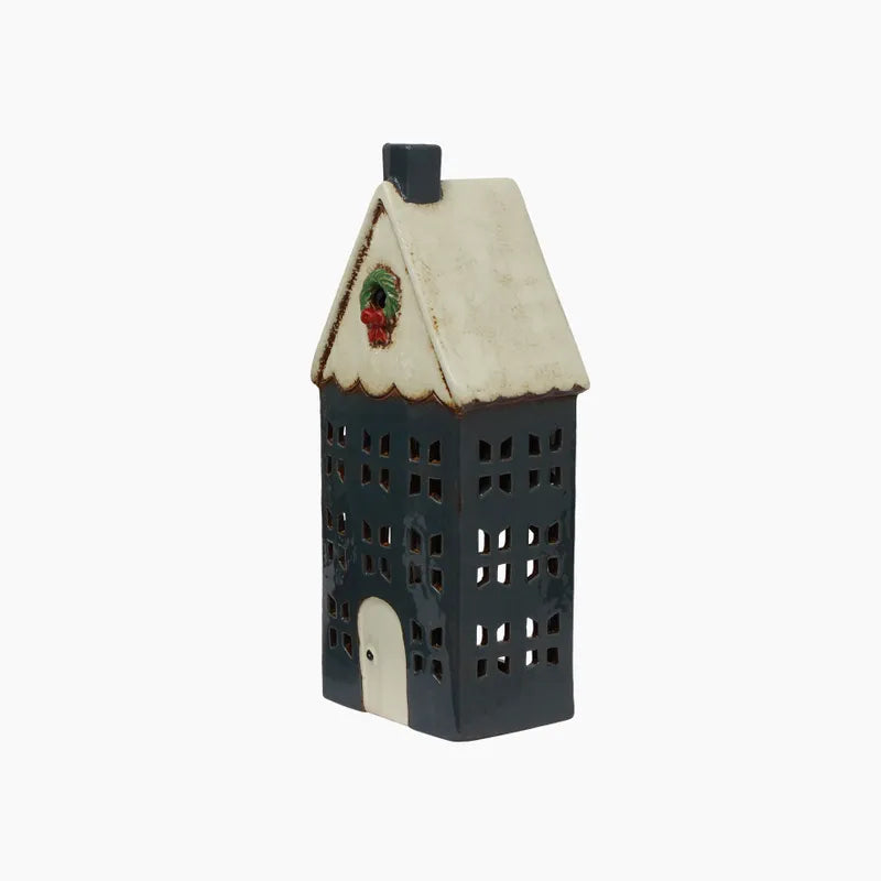 Blue ceramic tealight house with a cream roof and wreath on the front