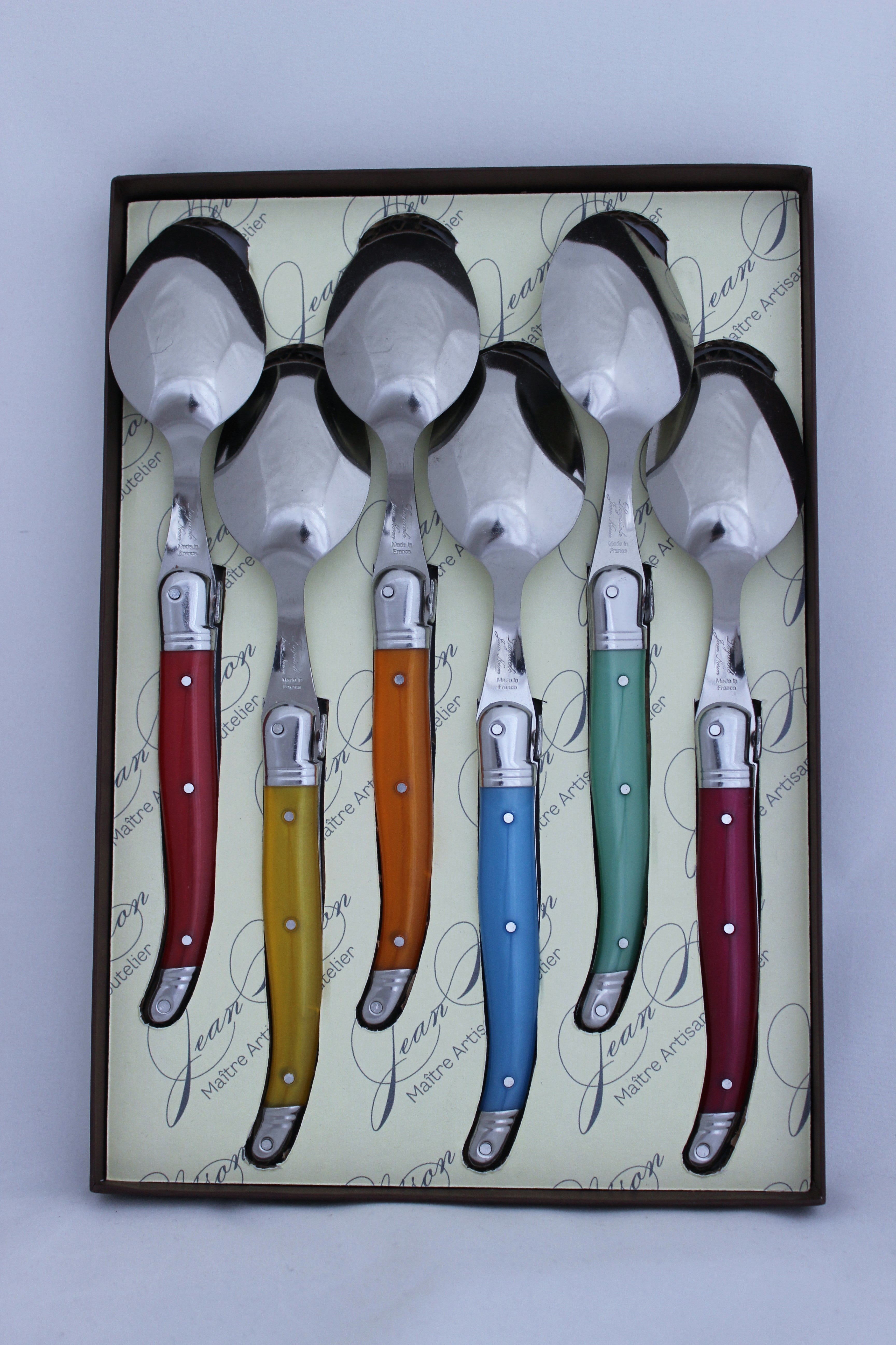 Laguiole Desert Sppons by Jean Nerson in a gift boxed set of 6 at Cerise.  Stainless Steel with coloured resin handles and dishwasher safe.