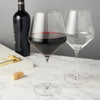 Stunning lead-free Crystal Glasses with tall stems and sleek angles. Enjoy your vintage with this pair of beautifully crafted red wine glasses equally suited for white wines.. Pure elegant drinkware in a boxed set of 2 with 21 oz capacity. 230mm H  Hand wash recommended. Dishwasher safe (top rack only)