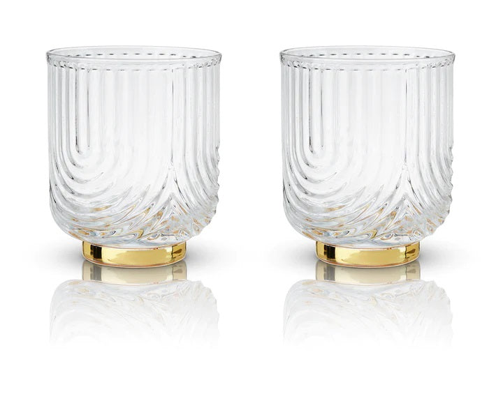 These 1920"s style elegant glasses feature a draping style glass offering a striking silhouette with polished gold plated base. Perfect for whiskey, margarita, negroni and more.  Boxed set of 2 Belmont Gatsby 12 oz Glasses.  High quality glass with gold electroplating.  Handwash only.